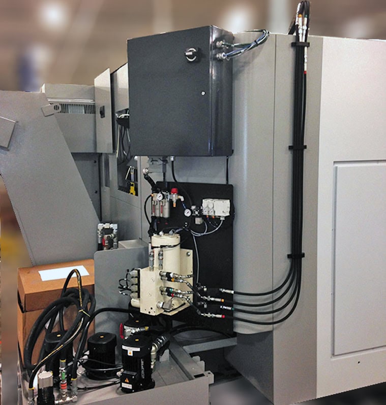 Hydraulic integration system with control panel, hoses, and components for machine tending and workholding solutions in manufacturing.