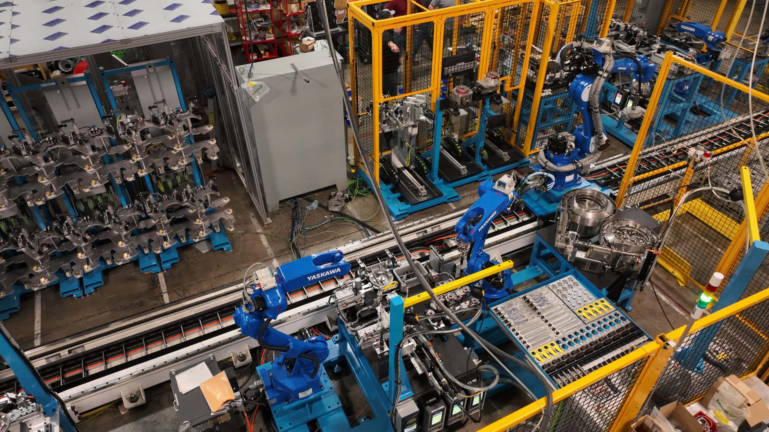 Assembly Automated assembly line featuring Yaskawa robots, precision fastening systems, and integrated machinery for efficient production processes.